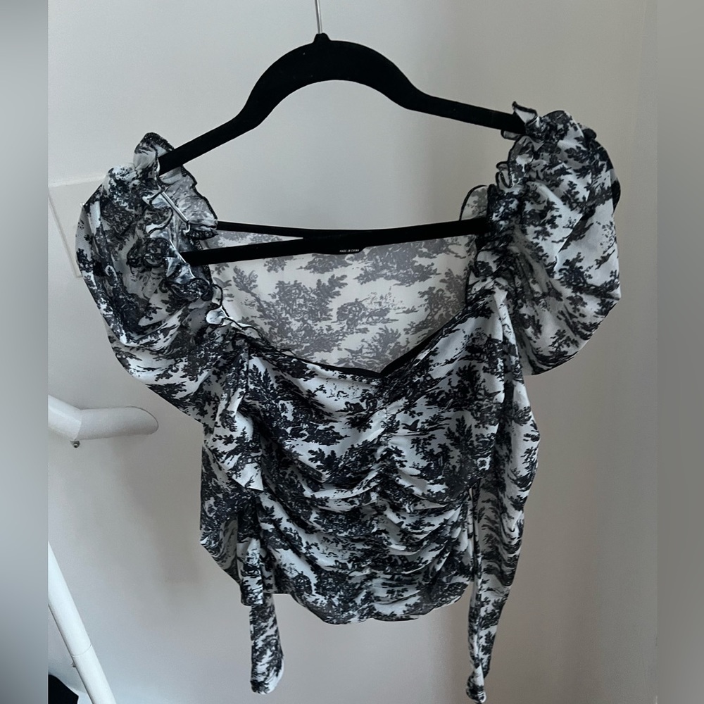 Black and white top with puff sleeves.
